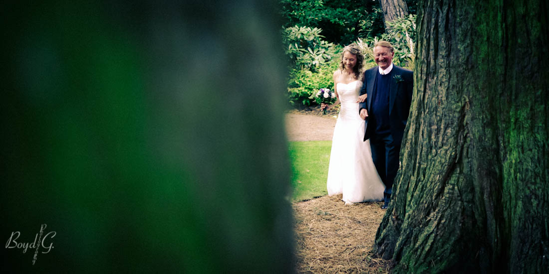 Father of the bride walking his daughter down the isle in in Botanical Gardens